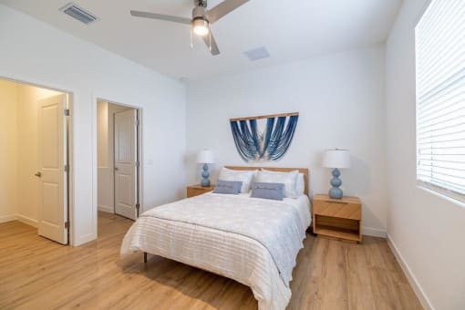 A bedroom with a bed and a ceiling fan