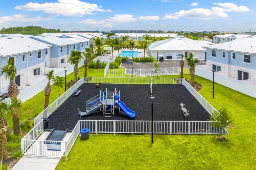 An aerial view of a playground and a pool in an apartment complex