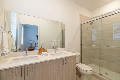 A bathroom with a sink toilet and a shower