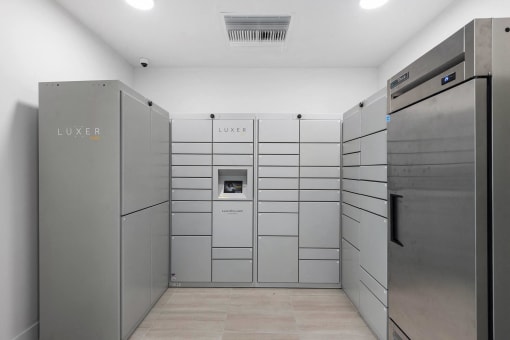 The laundry room has stainless steel appliances and white walls