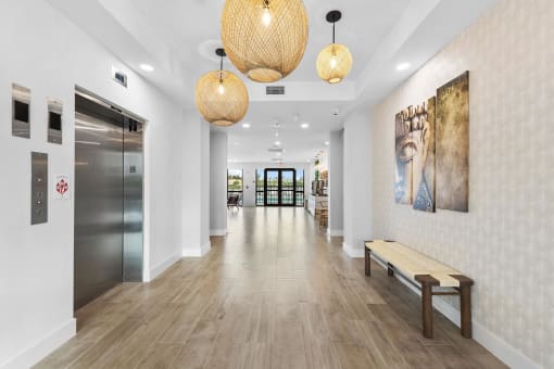 A long hallway with a bench and hanging lights