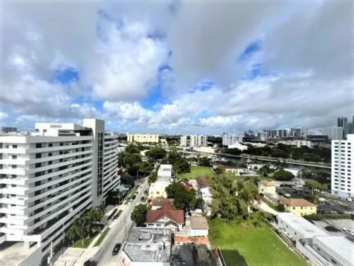 an aerial view of a city with tall buildings