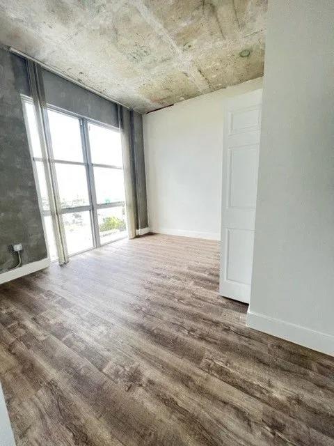 an empty room with a door and a window