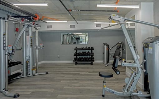 a gym with weights and other equipment in a home gym