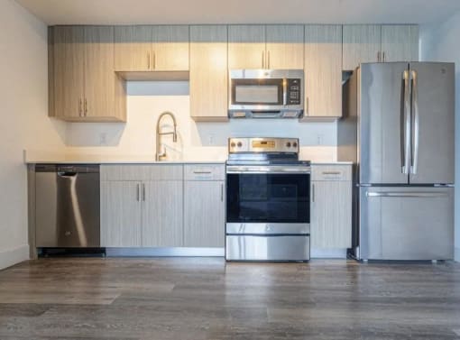 a kitchen with stainless steel appliances and white cabinets