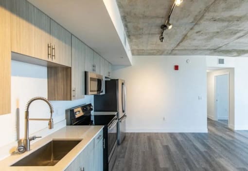a kitchen with a sink and a refrigerator