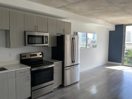 an empty kitchen with a stove and a refrigerator