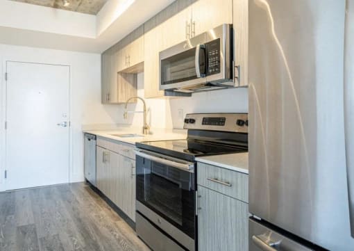a kitchen with stainless steel appliances and white cabinets