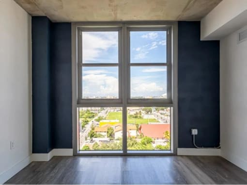 a living room with a large window and a view of the street