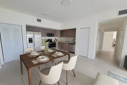 a dining room and kitchen with a table and chairs