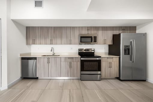 a kitchen with stainless steel appliances and wooden cabinets
