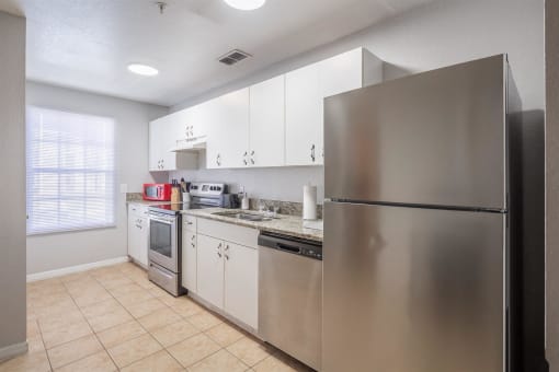 a kitchen with stainless steel appliances and white cabinets