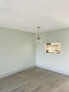 an empty living room with white walls and wood floors