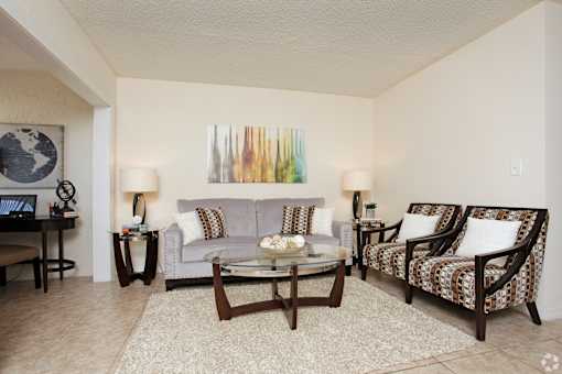 A living room with a couch, chair, and coffee table.
