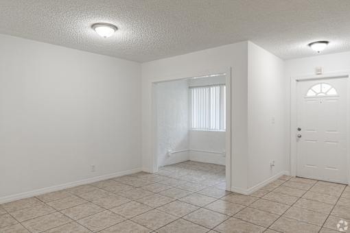 A room with white walls and a tiled floor.