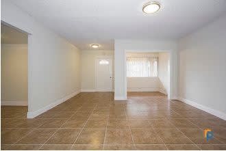 A room with tiled flooring and white walls.