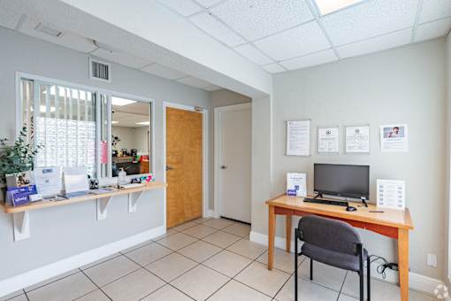 A room with a desk and a chair.