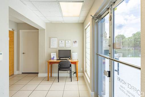 A room with a desk and a computer on it.