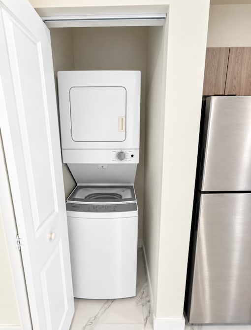 A white washing machine and dryer in a small laundry room.