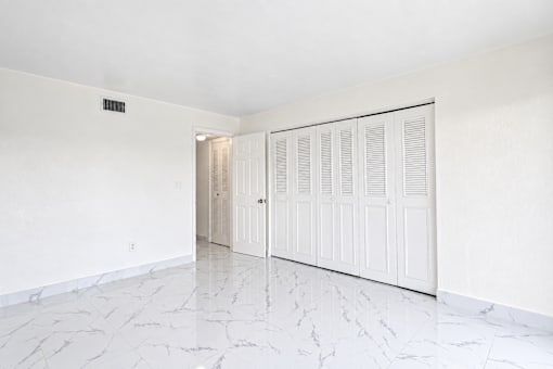 A white room with a marble floor and a white wardrobe.