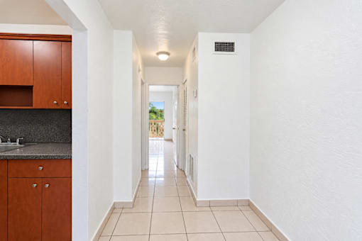 A long hallway with a door at the end.