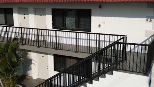 A black metal railing on a staircase.