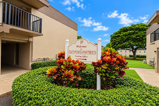 A sign for Southpointe Apartments is in front of a building.