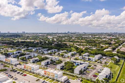 A view of a residential area with houses and cars.