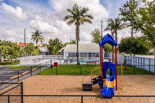 A playground with a blue slide and a red and yellow structure.