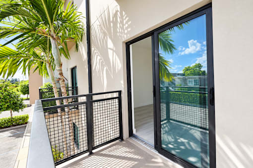 A black gate is in front of a white building.
