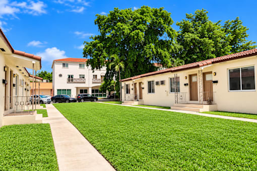 A sunny day at a residential area with houses and green lawns.