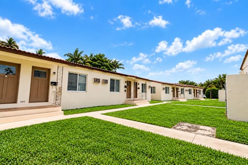 A row of houses with brown doors and windows.