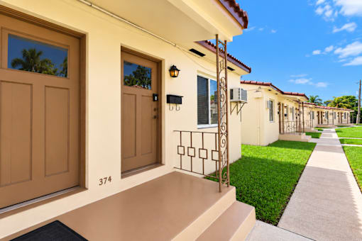 A house numbered 374 has a brown door and a black mailbox.