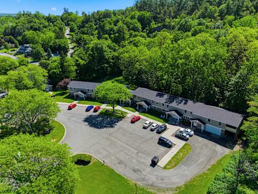 A parking lot with cars and a building in the background.
