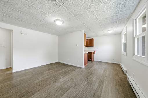 A room with wooden flooring and white walls.