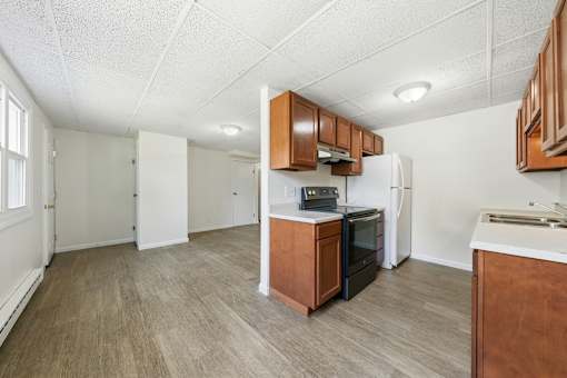 A kitchen with a refrigerator, oven, and microwave.