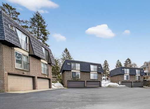 A row of houses with garages in front of them.