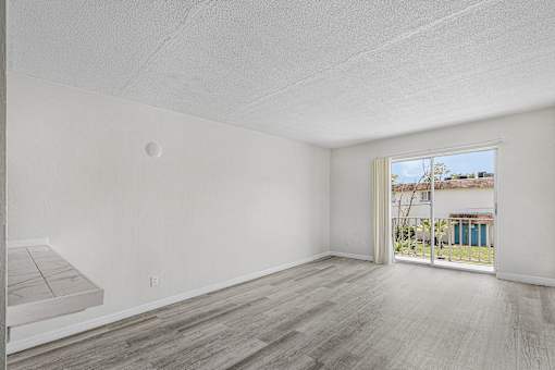 A room with a wooden floor and white walls.