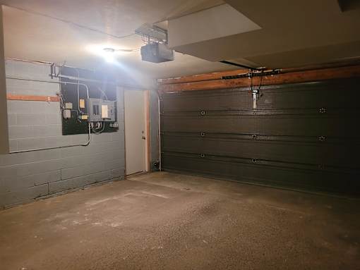 A garage with a concrete floor and a ceiling fan.