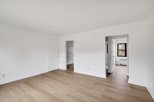 A room with wooden floors and white walls.