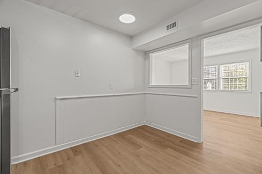 A room with white walls and wooden flooring.