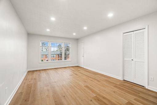 A room with wooden floors and white walls.