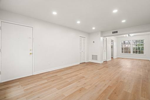 A room with wooden floors and white walls.