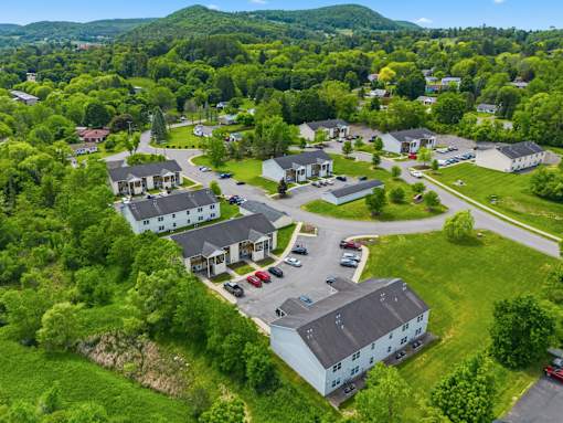 A bird's eye view of a residential area with houses and cars.