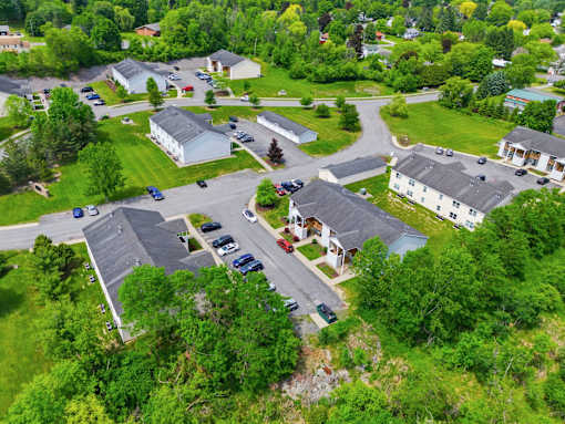 A bird's eye view of a residential area with houses and cars.