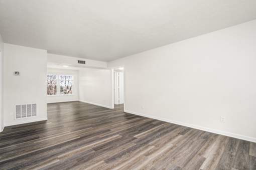 A room with wooden floors and white walls.