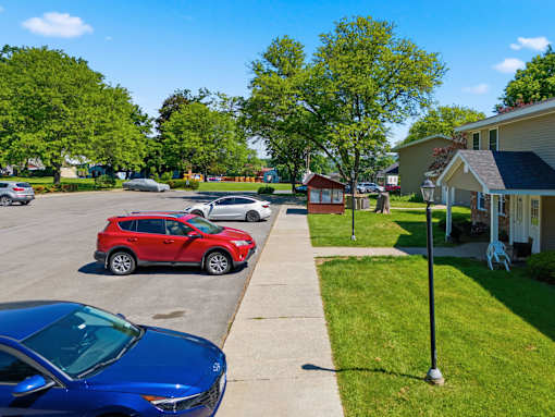 A red car is parked in a parking lot.