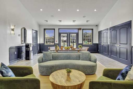 A modern living room with a large grey sofa and a wooden coffee table.