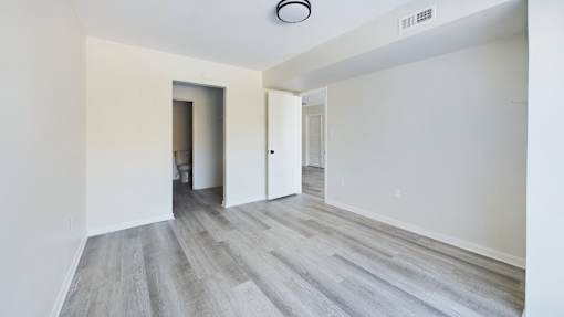 A room with a grey floor and white walls.