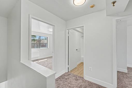 A white room with a window and a door.